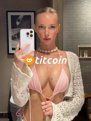 Pink swimwear mirror photo with the Titcoin logo